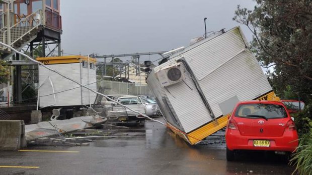 Crushed: A demountable building landed on a car after being blown over by the tornado.