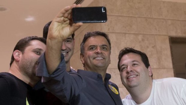 Brazilian presidential candidate Aecio Neves takes a selfie with supporters in Rio de Janeiro.