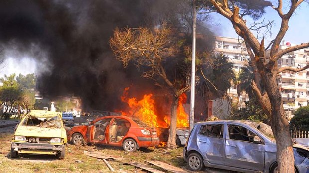 Flames and smoke rise from burned cars after a huge explosion shook central Damascus, Syria.