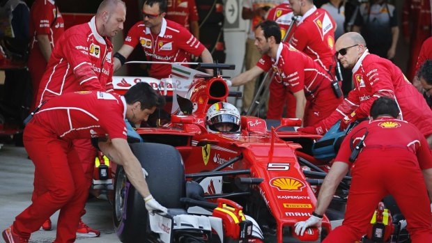 To the limit: Ferrari pit crew push Sebastian Vettel's Ferrari in the pits during the Formula One Grand Prix of Russia.