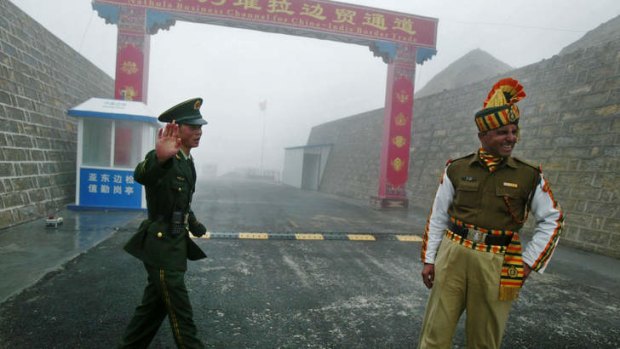 A Chinese soldier (L) and an Indian soldier stand guard at the Chinese side of the ancient Nathu La border crossing between India and China in 2008.