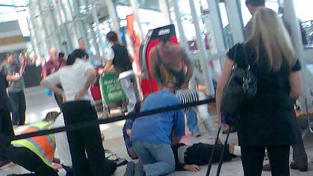 The victim lies on the floor in the domestic terminal.