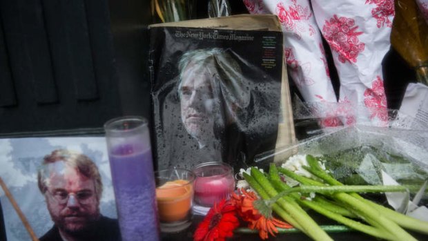 Tribute: A vigil of candles, flowers and portraits sits outside the apartment of actor Phillip Seymour Hoffman.
