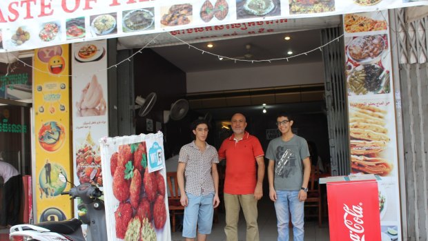 Hashim Farhan, 51, with his sons, Emad, 18, right, and Jassir, 22 at their restaurant in Phnom Penh.

