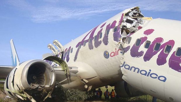Clean break ... the packed Caribbean Airlines jet carrying 163 people split in two after it landed in Guyana.