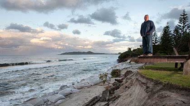 Cry for help ... John Vaughan surveys his fast disappearing front lawn.