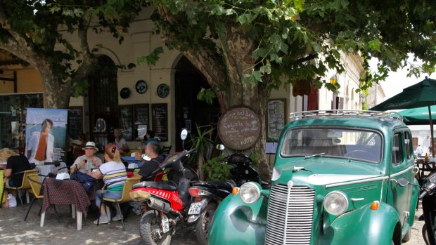 Colonia's quirky El Drugstore cafe, where vintage cars have been parked outside and remodelled into seating booths.