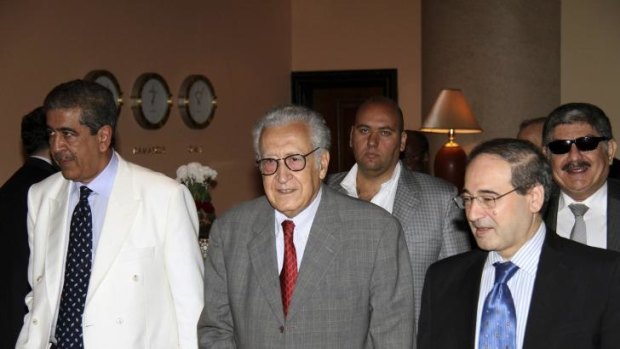UN-Arab League peace envoy for Syria Lakhdar Brahimi (C) walks with Syrian Deputy Foreign Minister Faisal Mekdad (front R) and Mokhtar Lamani, Brahimi's representative in Syria (L). 