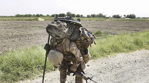 Taking a breather ... US marine Corporal Brian Knight, weighed down by his equipment, pauses to rest in Afghanistan's Helmand province.