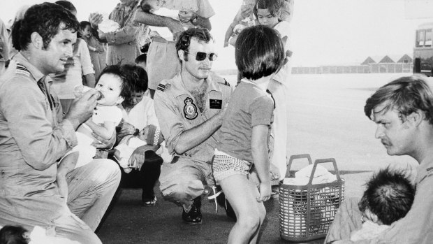 A photograph from the Australian War Memorial archives showing Operation Babylift and   "a case of `all hands to the bottles' during the second RAAF airlift of Vietnamese orphans. Seen here feeding babies at Tan Son Nhut airfield were three crew members from 37 Squadron: (from left) Flight Lieutenant (FLTLT) Ian S. Frame, FLTLT H.F.B. Howell and Flying Officer Ian K. Scott. (Donor I.S. Frame)''.