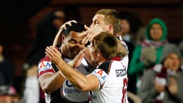 Tony Williams of the Sea Eagles celebrates with team mates after scoring a try.