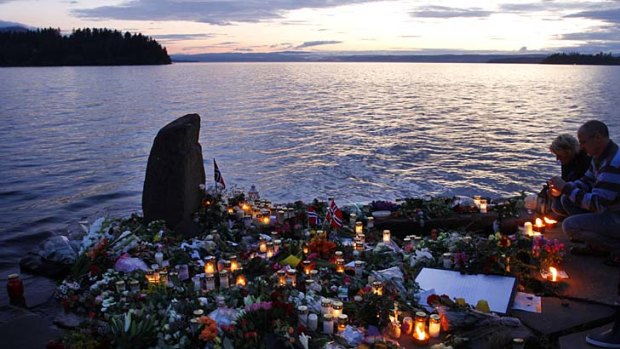 Memorial ... people place candles in Utvica near Sundvollen, in front of Utoya island.