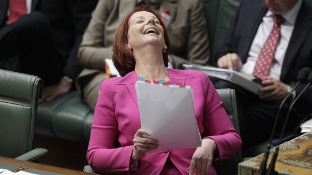 Julia Gillard laughs off the Opposition's attack in Parliament yesterday.