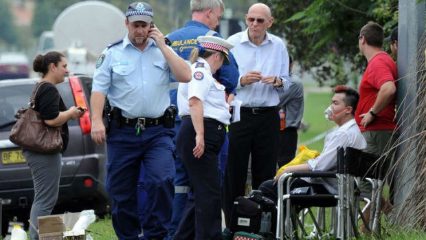 Roger Dean, seated, is given oxygen after the fire engulfed the Quakers Hill nursing home.
