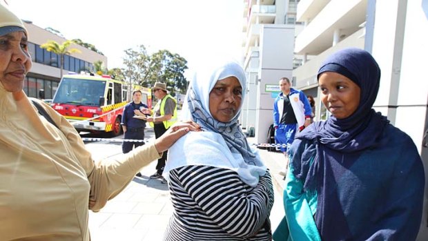 Blocked off ... Nada Buraleh, centre, with her daughter Samira, right, and her aunt Sahra Ahmed wait for access to a unit days after a fire in which one woman died.