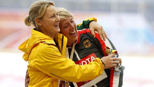 Friendly foes: Silver medallist Kim Mickle (left) hugs German Christina Obergfoll, who won javelin gold.