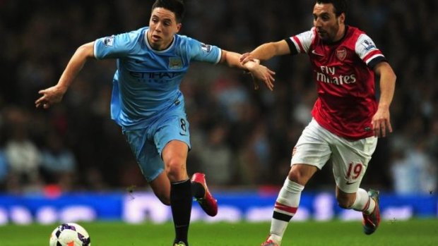 Tight tussle: Samir Nasri of Manchester City escapes from Arsenal's Santi Cazorla.
