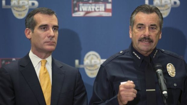 LA police chief Charlie Beck, right, comments on Sony Studios hackers' threats at a news conference.