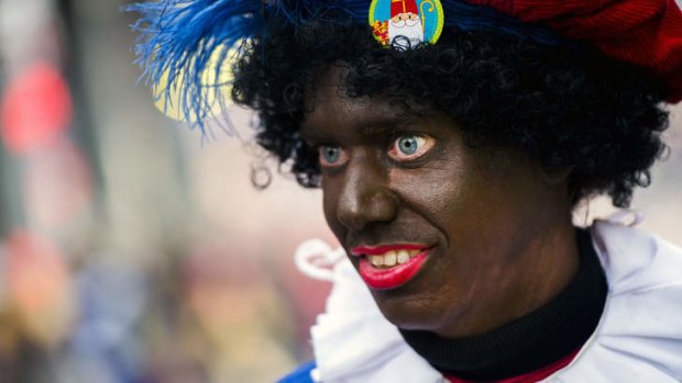 A woman dressed as Zwarte Piet (Black Piet) takes part in the Sinterklaas festival in the Netherlands.