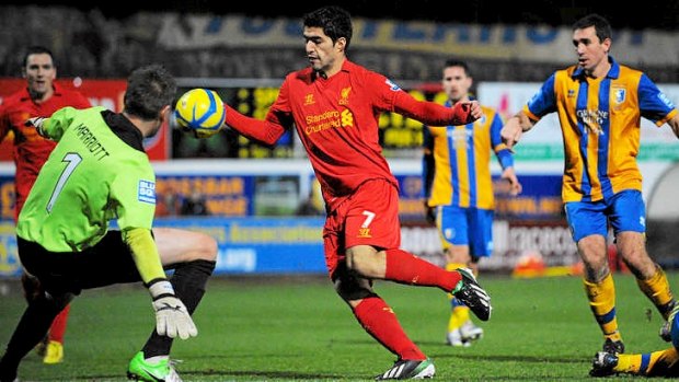 Caught in the act ... Liverpool's Luis Suarez (C) handles the ball in the lead up to to scoring the winning goal against Mansfield in the FA Cup.