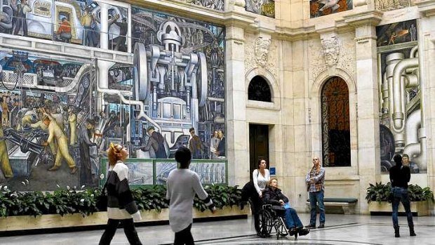 People look at a mural by artist Diego Rivera at the Art Institute of Detroit in Detroit, Michigan.