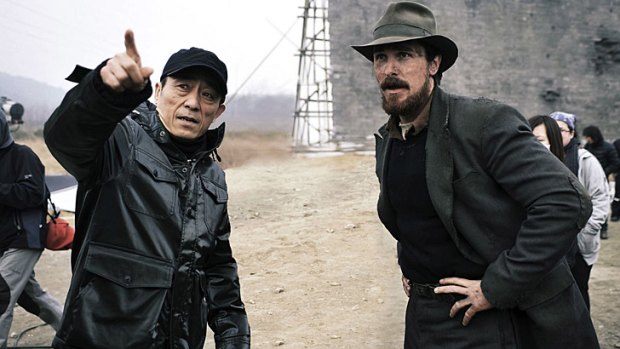 Zhang (left) with Christian Bale on the set of <i>The Flowers of War</i>.