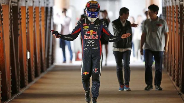 Mark Webber of Australia gestures upon arriving back near the pit area after his car caught fire during the Korean F1 Grand Prix at the Korea International Circuit.