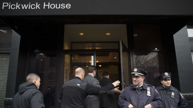 Police stand guard outside the  home of actor Philip Seymour Hoffman.