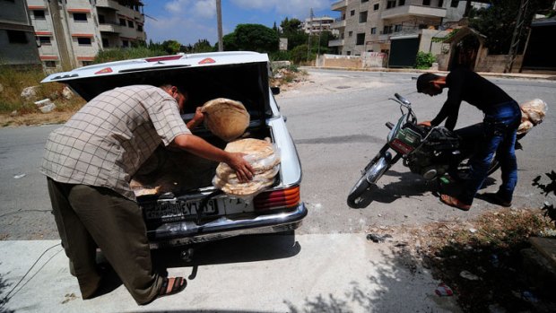 Bread made by the one baker still operating in this area is loaded into a car for distribution to Salma’s remaining residents.