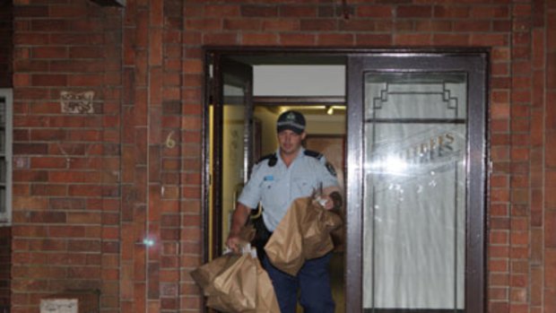 Police take evidence from Ian Gray's apartment.