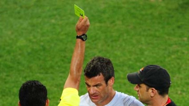 Carlos Batres shows a yellow card to New Zealand's Ryan Nelsen