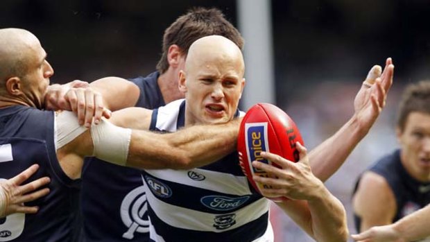 Cunning Cat Gary Ablett looks for an escape route but can't evade a Carlton gang tackle, led by fellow midfielder Chris Judd (left).
