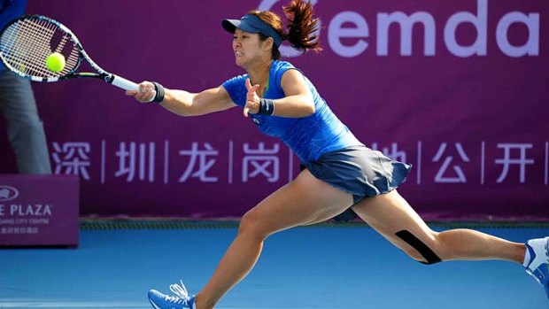 Li Na hits a return to Klara Zakopalova during the Shenzhen Open women's final.