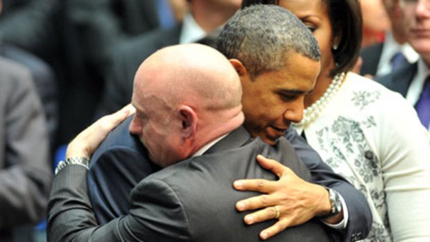 "Our hopes and dreams are bound together" ... Barack Obama embraces Mark Kelly, the husband of the injured congresswoman Gabrielle Giffords, at the memorial service for victims of the Tucson shooting.