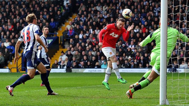 Manchester United's striker Wayne Rooney heads home a goal.