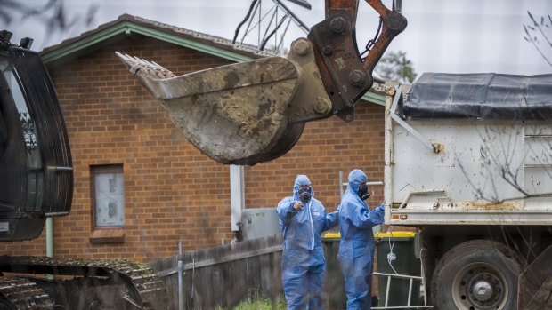 Workers demolish a Mr Fluffy home in the Canberra suburb of Farrer this week.