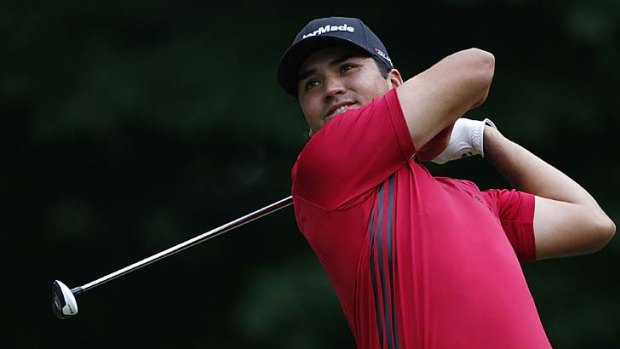 Jason Day hits a shot during the first round of the John Deere Classic in Illinois.