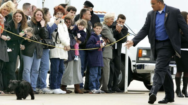 A Secret Service agent chases Barney as he struts past a line of well-wishers seeing off the President at Waco TSTC airport in 2004.