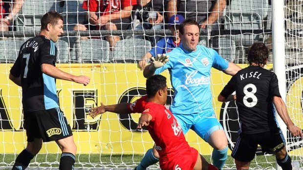 Goalmouth scramble ... Sydney's Karol Kisel is shut down by some desperate Adelaide United defence in the form of Cassio and goalie Eugene Galekovic.