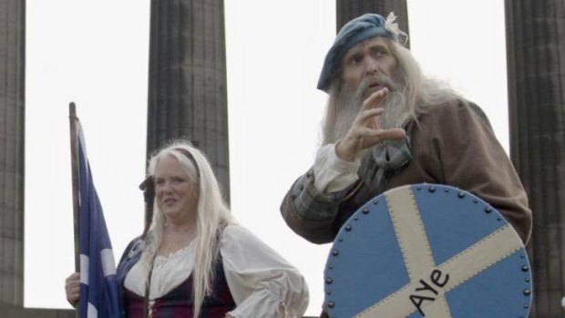 Members of a Scottish historical re-enactment group at the National Monument on Calton Hill in Edinburgh. The monument has remained unfinished after funds ran out nearly two centuries ago.