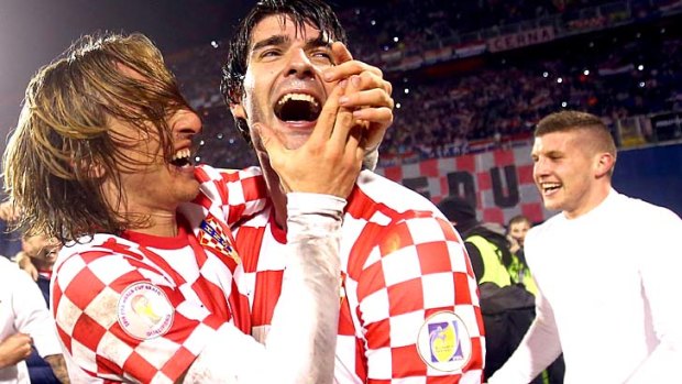 Luka Modric (L) and Vedran Corluka of Croatia celebrate after qualifying for the World Cup.