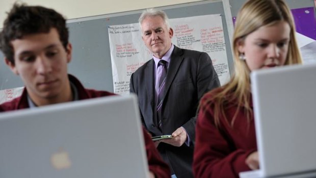Ringwood Secondary College principal Michael Phillips, with students Dylan Hornsby and Kirsty Gayther, believes students should use computers in their VCE exams.