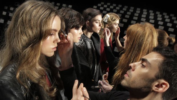 Models get final touches to their make-up at New York Fashion Week.