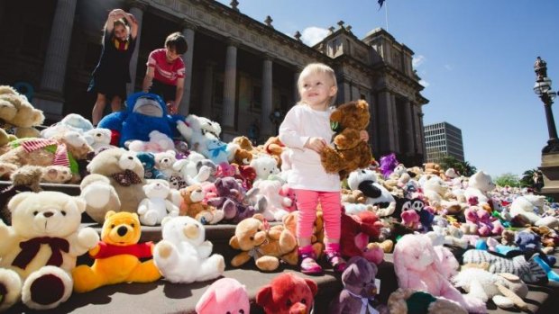 Teddy bears are placed on the steps of Parliament House to symbolise the victims of domestic abuse.