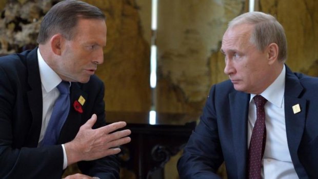 No shirt-fronting: Australian Prime Minister Tony Abbott speaks to Russian President Vladimir Putin at the APEC leaders' summit in Beijing.
