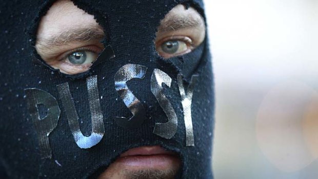 A masked man attends a rally in support of Russian punk band Pussy Riot  in Sydney  today.