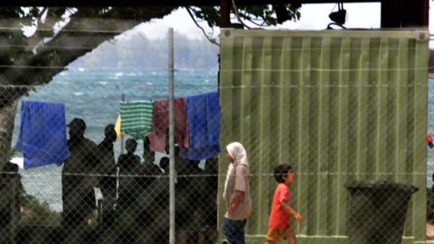 Asylum seekers at Lombrum Naval Base, Manus Island. Shipping containers surrounded by cladding and fitted with air-conditioners are their accommodation.