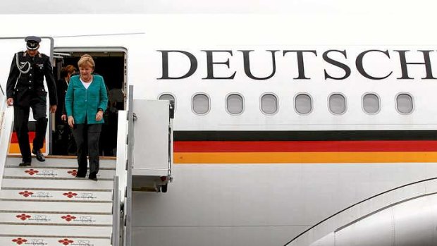 German Chancellor Angela Merkel disembarks from at Belfast International airport in Belfast, Northern Ireland, to attend the G8 summit at the Lough Erne resort.