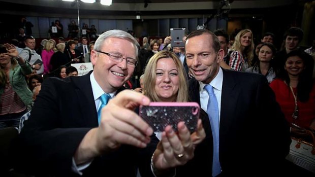 Slow blows on fight night: Kevin Rudd and Tony Abbott pose for a photo with Nada Makdessi at the Rooty Hill RSL leaders' forum.