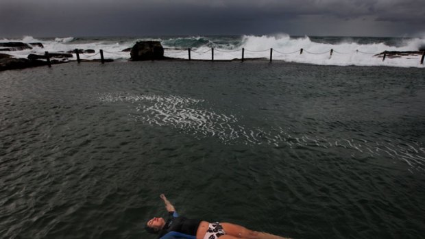 Wet and wild ... a lone swimmer braves the cold and blustery weather at Mahon Pool in Maroubra yesterday. The eastern suburbs are expected to cop the heaviest rain in the next few days.